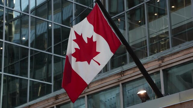 Canadian flag on building in downtown district of Ottawa in Canada, close up