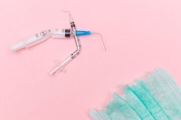 Anti Vaccine Movement and Anti Mask Concept - Broken Medical Syringe and Green Torn Medical Face...