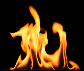 fire on a black background, burning and hot flames, close view