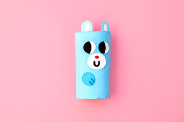 Christmas toy from toilet tube roll, paper toy santa claus, snowman, reindeer, tree rabbit on pink background. Holiday easy kids DIY, decoration idea for winter season, home party. Children's crafts