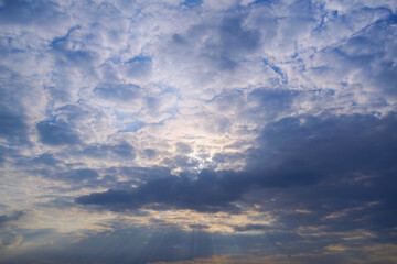 Summer evening sky in the picturesque clouds, lit by the rays of the setting sun.