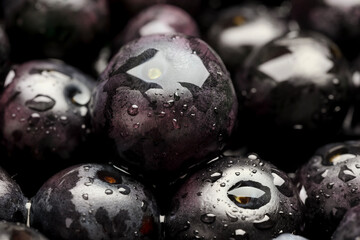 Wet acai berries as background, closeup view