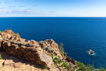 View of the Azure Mediterranean Sea with the foreground of the red rocks