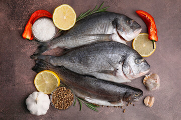 Sea food. Different types of raw fish and products on brown table, flat lay