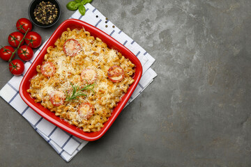Delicious al forno pasta in baking dish on grey table, flat lay. Space for text
