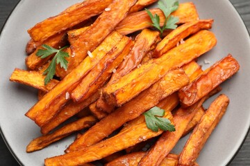 Delicious sweet potato fries with spices on table, top view