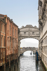 Venice, Italy - February 7, 2024: Gondolas sail under the bridge of sighs (Ponte dei Sospiri) in Venice, Italy