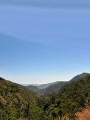 lush green mountain range with open blue sky
