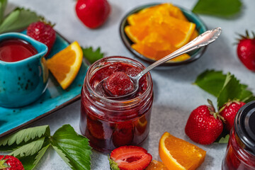 Homemade strawberry jam with fresh strawberries and orange slices