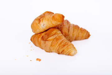 Close-up of golden croissants on a white background, showing detailed texture in an infinite white setting for a clean, minimal look