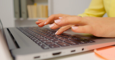 Hands of professional business woman typing on laptop notebook keyboard. Working remotely from home office on software apps. Technology concept.