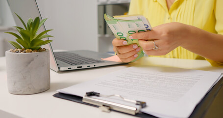 Woman counting euro cash above the clipboard. Investment money saving for future. Money concept.