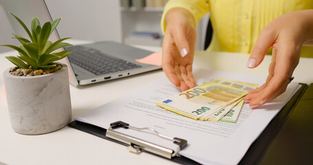 Opening a clipboard female hands counting bill for payday. Money investing in assets by business woman.
