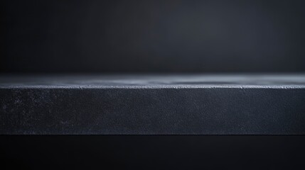 Shot of a table top lit very subtly to keep dark and grey, ideal for use as a background image that can be changed in colour to meet needs of designer