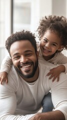 Obraz premium Happy father playing with daughter in cozy indoor setting