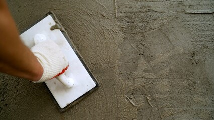 Construction worker applying plaster on the wall