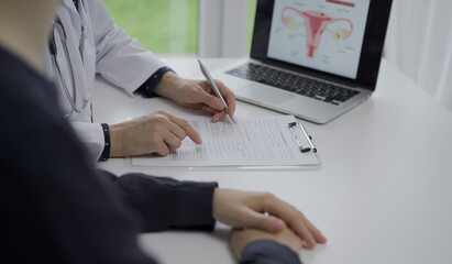 Doctor and a patient in clinic. The female physician is filling up medication history record form, close up of woman hands. Medicine concept