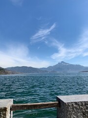 lake and mountains and dragon like cloud formation in the sky