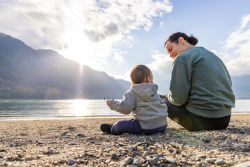 Mother and Child Enjoying Nature at Lakeside Beach