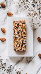 white marble background with granola bar and almonds for minimalist product photography and food branding design