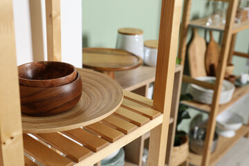 Wooden storage stands with kitchenware indoors, closeup
