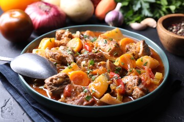 Delicious stew and different ingredients on table, closeup