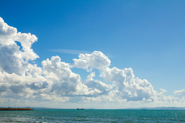 big white clouds in the deep blue sky over the sea landscape