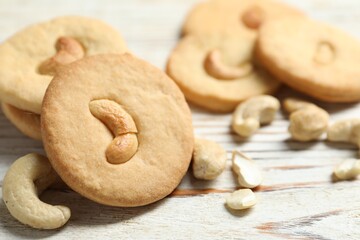 Tasty cashew cookies on rustic wooden table, closeup