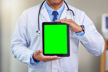 Man, hands and doctor with tablet for green screen, advertising or medical app at hospital. Closeup, male person or healthcare professional by technology display, mockup space or chromakey at clinic