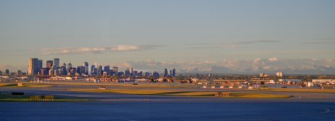 Calgary skyline at sunrise with rocky mountains in the background, panoramic landscape shot from...