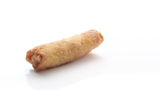 Crispy, freshly deep-fried spring roll appetizer from Chinese cuisine on a white background.