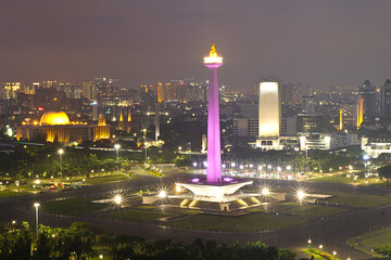 Jakarta city skyline with iconic symbol likes National Monument (Monas) at night. Jakarta, Indonesia