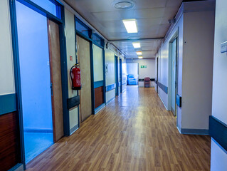 A Long Hospital Corridor Where Patients And Staff Transit From Room To Room Or Level To Level