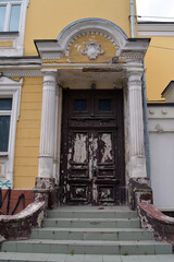 Old faded and peeling entrance and wooden door, Chisinau, Moldova