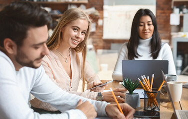 Close up of young multiracial business team working on project together in modern office