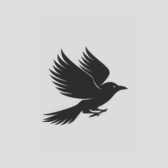 Obraz premium Silhouette of a crow in flight against a gray background.