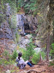 Woman looking down at Char Falls in Idaho.