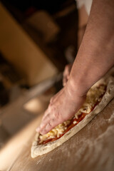 Generous amounts of cheese are spread over the pizza dough, promising a rich, gooey topping when baked. Use this for restaurant menus, food blogs ...