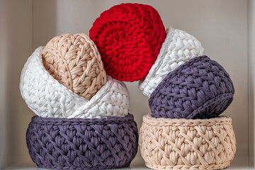 Colorful woven baskets arranged artistically in a cozy home setting showcasing various textures and...