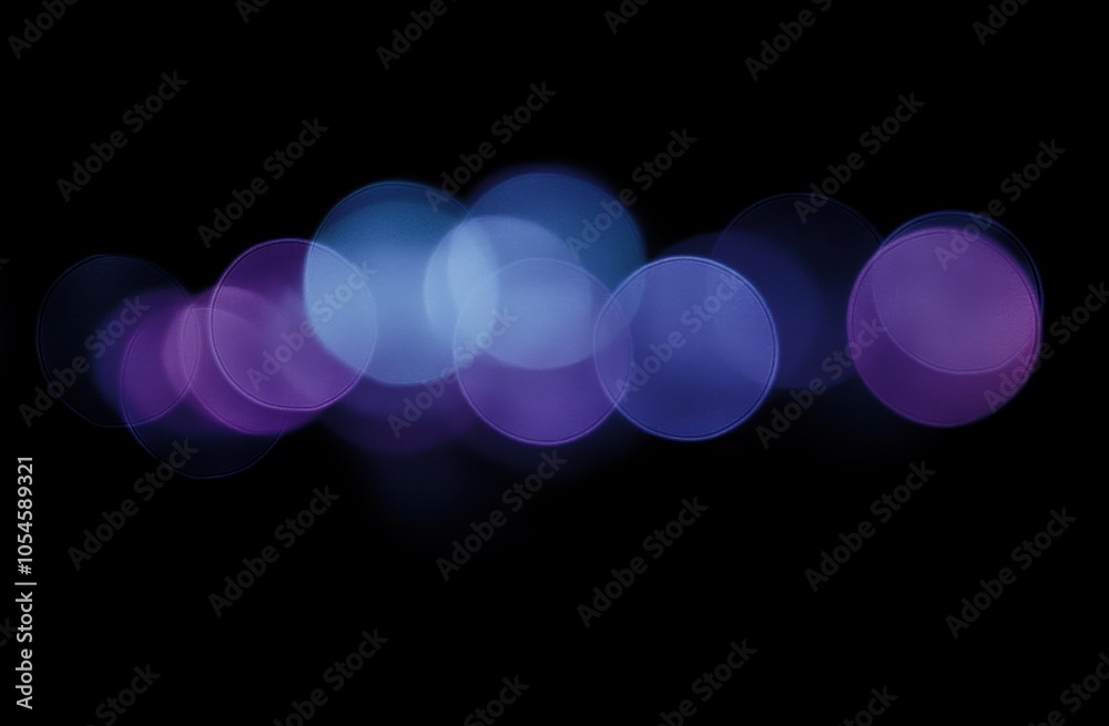 Poster Blurred bokeh lights on a black background with purple and blue colors, suitable for text overlay or as a design element. Blurry light effects with circles of defocused glow
