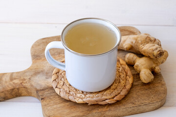 Ginger tea in a mug on a white background