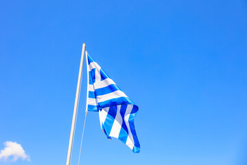 A blue and white flag is flying in the sky