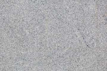 A gray tile floor with a pattern of small squares