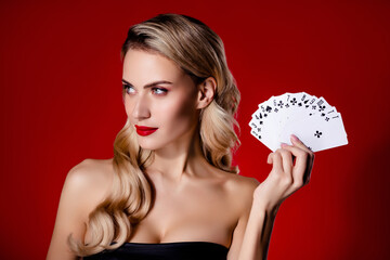 Photo of attractive girl lady hold playing poker cards look profile side isolated red color background