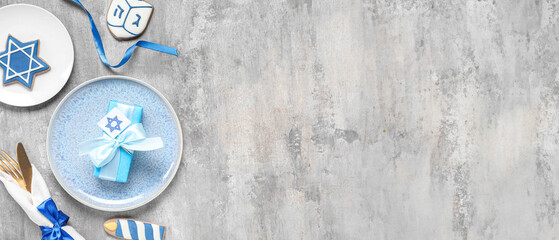 Festive table setting with Hanukkah decorations on grey grunge background