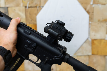 Obraz premium American rifle with thermal imaging sight at a shooting range, close-up photo.