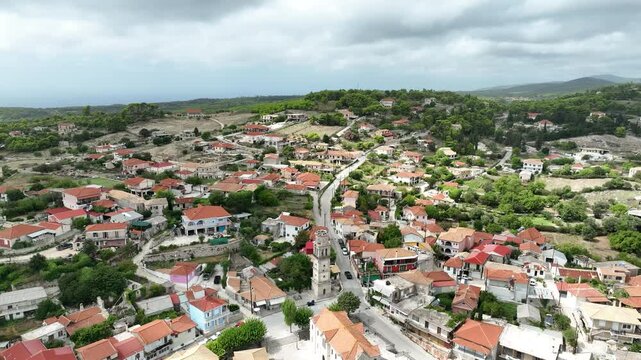 Flying over a town nestled between mountains on the Island of Zakynthos. Mavic 3
