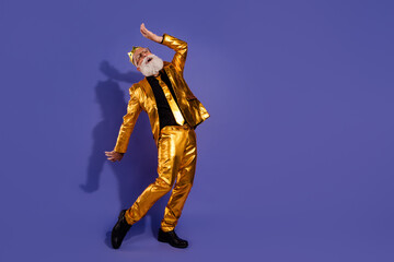 Full body photo of bearded gentleman dancing have fun wear fashionable golden clothes isolated on violet color background