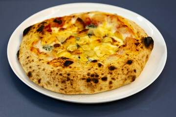 Traditional rustic pizza made with four cheeses, garlic and oil and pear with gorgonzola