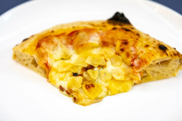 Traditional rustic pizza made with four cheeses, garlic and oil and pear with gorgonzola